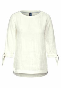 Blusa bianca e strutturata con maniche a tre quarti e dettagli legati ai polsini. Scollatura rotonda e orlo posteriore più lungo.