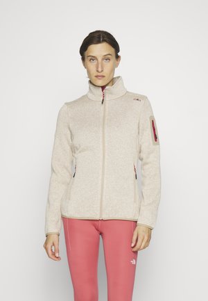 Beige fleecejacka med hög krage, framzipper och två sidofickor. Har rosa zipperdetaljer och en ficka på ärmen.