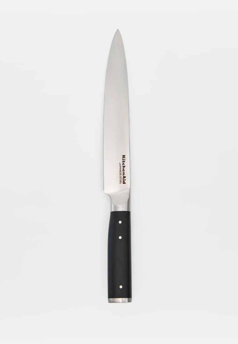 Couteau de cuisine KitchenAid en acier inoxydable, manche noir avec trois rivets métalliques, lame pointée vers le haut sur fond blanc.