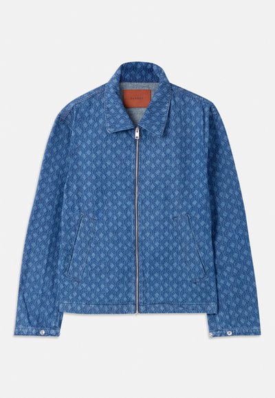 Chaqueta de denim azul con estampado y corte recto. Presenta un cierre de cremallera, dos bolsillos laterales y un collar clásico. Detalle de tejido texturizado.