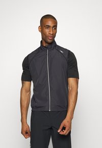 Schwarze ärmellose Jacke mit hohem Kragen und taillierter Passform, ausgestattet mit einem Reißverschluss vorne und kontrastierenden strukturierten kurzen Ärmeln.