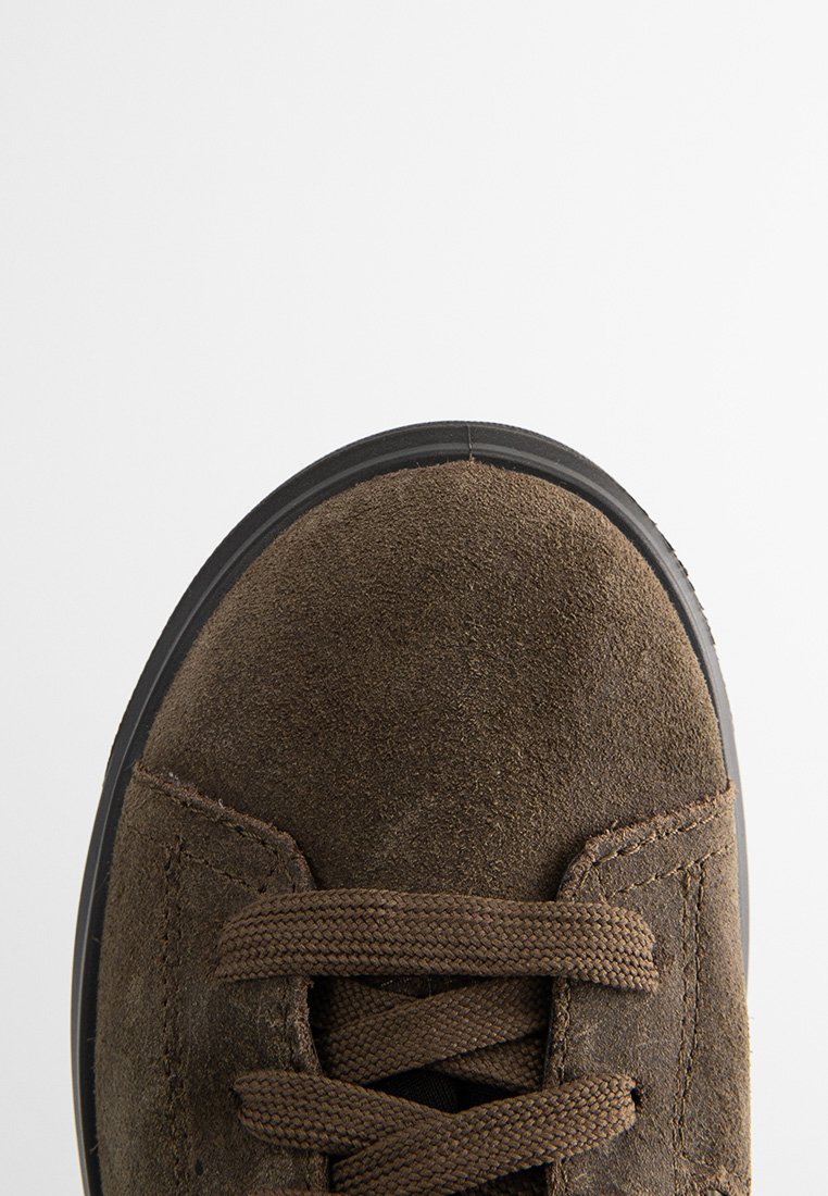 Braune Wildlederschuhe mit runder Zehenform, strukturiertem Obermaterial und braunen Schnürsenkeln. Verfügt über eine schwarze Gummisohle mit leichtem Profil.