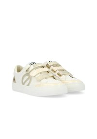 Beige and white sneakers made of faux leather, featuring double Velcro straps, rounded toe, and a textured rubber sole with a geometric cutout.