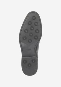 Schwarze Ledersohle mit rundem Profilmuster und strukturierten Akzenten. Verfügt über eine glatte Kante und ein markantes Markenlogo.