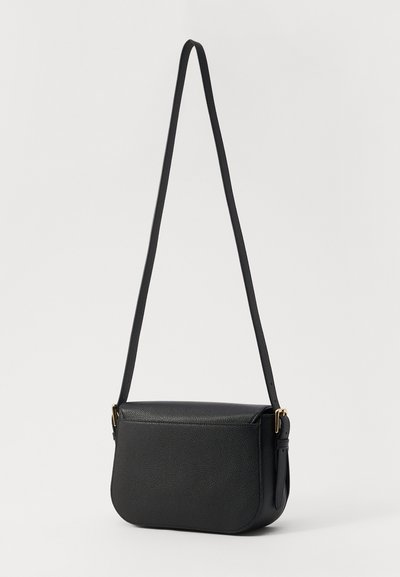 Black leather crossbody bag with a textured finish, curved bottom, long strap, and gold-tone hardware. Features a single compartment.