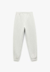Lys grå sweatpants lavet af blødt stof, der har en elastisk talje og samlede mansjetter ved anklerne for en tapered pasform.