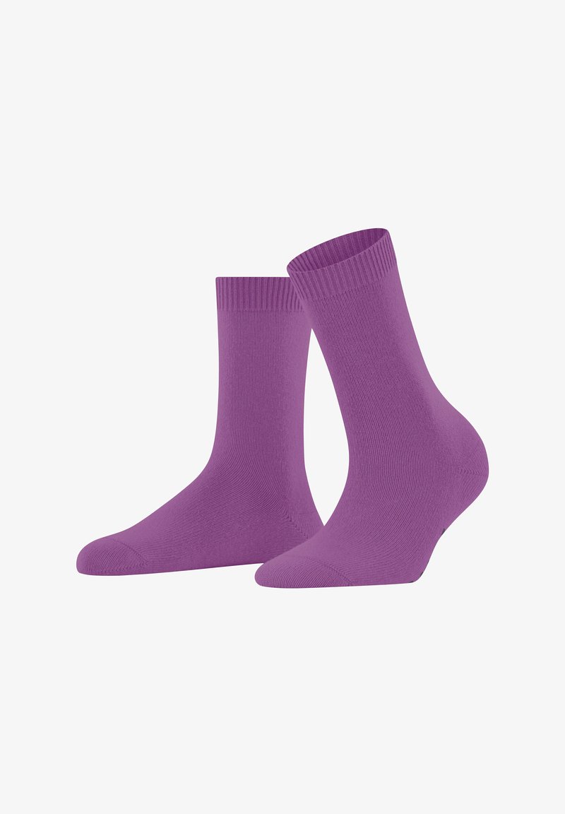 Un paio di calzini crew viola semplici in piedi su uno sfondo bianco, realizzati in tessuto a maglia fine con polsini a coste.