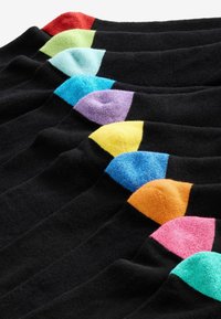 Black socks with contrasting brightly colored heel accents in red, green, blue, purple, yellow, orange, and pink, arranged in a row.