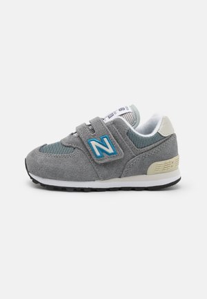 Gray and teal toddler sneaker with velcro straps, suede and mesh materials, white cushioned interior, and a textured sole.