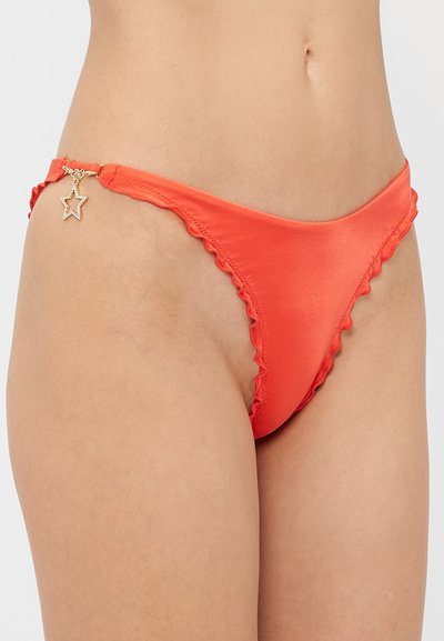 Red bikini bottom with ruffled trim, featuring a gold star charm on the side, made from a smooth, shiny material.