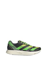 Chaussure de course noire avec des rayures vertes et jaunes, des lacets verts et une semelle blanche portant la mention Lightstrike Pro.