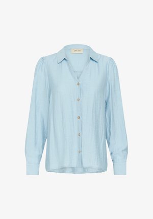 Camicia button-up azzurro chiaro con scollo a V, maniche lunghe a sbuffo e un tessuto leggermente texturizzato. Presenta bottoni di legno lungo la parte anteriore.