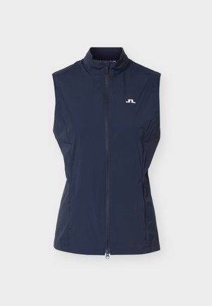 Veste sans manches bleu marine avec fermeture éclair, col montant et petit logo blanc sur le côté gauche de la poitrine, sur fond uni.