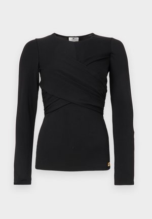 Svart langermet topp med vikdesign og elastisk stoff. Har rund hals og et lite logoakcent ved sømmen.
