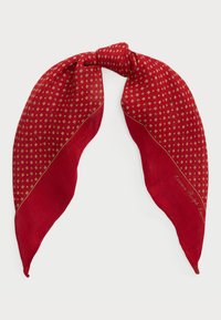 Red scarf featuring a diamond pattern in gold with a smooth texture, finished with a tied knot at the top and a contrasting solid red section.