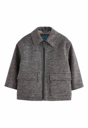 Veste courte à fermeture éclair pied-de-poule grise et noire avec un large col et deux poches avant à rabat.