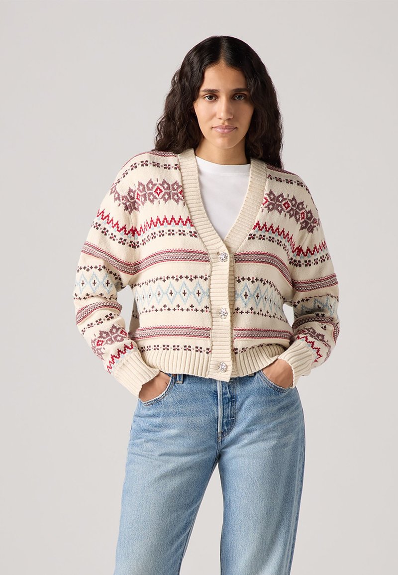 Knit cardigan in cream with red and blue geometric patterns, featuring a V-neck, ribbed cuffs, three buttons, and a relaxed fit.