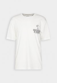 T-shirt en coton blanc avec un col rond, des manches courtes et un imprimé graphique montrant un chien de dessin animé et le texte "L'AVENIR EST PROMETTEUR."
