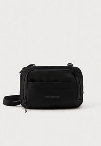 Black nylon crossbody bag featuring a zippered front pocket, adjustable strap, and subtle logo detailing on the front. Smooth texture.