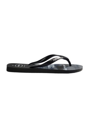 Sandale flip-flop noire avec semelle texturée, brides noires et logo blanc « Havaianas » sur la bride, vue de côté.