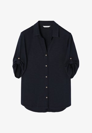 Marineblå kortærmet skjorte med knaplukning foran, inklusive gyldne knapper og krave, der kan foldes ned. Blødt, struktureret stof med en afslappet pasform.