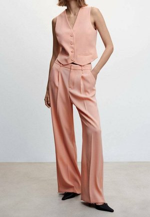 Peach-colored tailored vest with five buttons, paired with wide-leg trousers. Smooth texture, minimalist design, featuring side pockets.