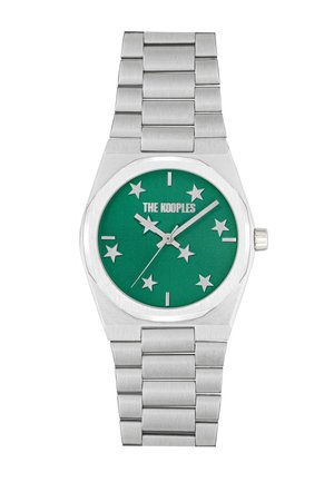 Silver metal watch with a polished finish, featuring a green dial, star markers, and a textured stainless steel bracelet.