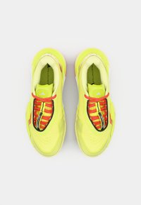 Neon yellow running shoes with a textured upper, black accents, and vibrant red laces. Features a padded collar and logo branding.