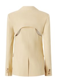 Blazer beige con un design a schiena aperta, colletto appuntito e polsini con bottoni. Tessuto morbido e vestibilità su misura con spacchi laterali per un tocco aggiuntivo.