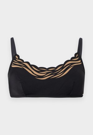 Svart bralette med tynne stropper og en bølget utringning med beige, bølgete, gjennomsiktig mesh-detalj.