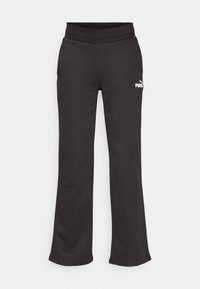 Zwarte sweatpants van zachte stof, met een wijde pijpdesign, elastische tailleband en een wit Puma-logo aan de linkerkant.