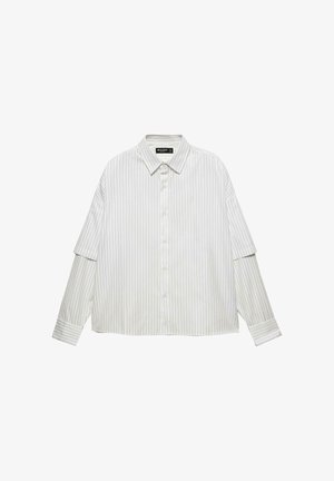 Hvid skjorte med lodrette grå striber. Har en klassisk krave, løs pasform og lange ærmer med manchetter.