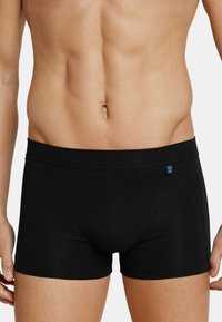 Zwarte boxershorts gemaakt van zachte stof. Kenmerken zijn een snug fit, gladde textuur en een klein logo op de tailleband.