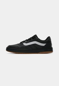 Black sneaker with a textured leather upper, white stitching accents, and a gum rubber sole. Features a classic lace-up design.