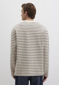 Langarmhemd in Creme mit dünnen schwarzen Streifen, runder Ausschnitt und lässiger Passform. Weicher Stoff mit glatter Textur.