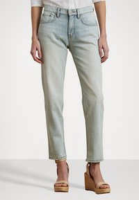 Lysvaskede denimjeans med rett ben-design, med fem-lomme stil, sydd detaljer og en litt frynset kant.