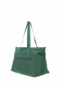 Sac cabas en tissu vert avec deux longues poignées. Présente une surface texturée et une fermeture éclair en haut. Forme rectangulaire simple.