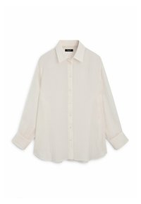 Chemise blanche à manches longues avec col pointu et poignets, réalisée en tissu léger et texturé.