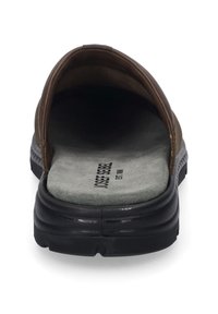 Brown slip-on sandal with a cushioned insole, black rubber sole, and a smooth finish, featuring a wide strap for comfort.