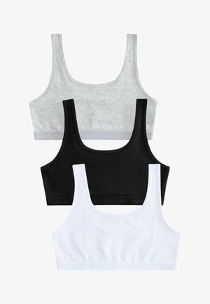 Three crop tops in grey, black, and white cotton. Each has wide straps and a branded elastic band at the bottom, featuring seamless edges.