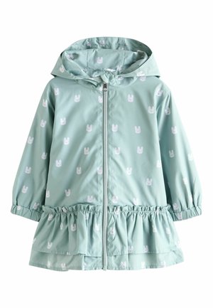 Miętowozielony płaszcz przeciwdeszczowy z wzorem białych króliczków, elastycznym marszczonym dołem, zamkiem z przodu i kapturem. Wykonany z lekkiego materiału.