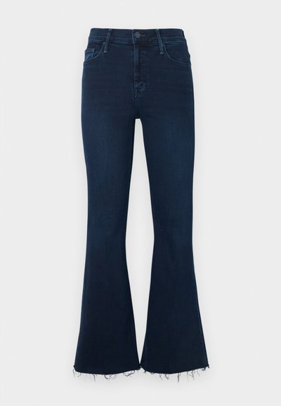 Tumesinised laienevad teksapüksid, valmistatud denimist, kõrge vöökohaga ja sasitud äärega. Klassikalise viie taskuga disain metallist nööbi sulgemisega.