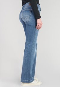 Light blue jeans with a straight leg design, featuring a button and zipper fly, back pockets, and a slightly faded texture.