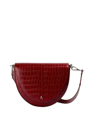 Bolso bandolera semicírculo rojo con textura de cocodrilo, emblema plateado de calavera en el frente y correa de hombro desmontable con cierres metálicos.