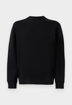 Sweatshirt noir avec un col rond, des manches longues et une texture douce. Présente un logo discret sur la poitrine et une coupe décontractée.
