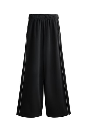 Mustat leveälahkeiset housut, joissa on joustava vyötärö, valkoiset sivupaneelit ja sileä, kevyt kangas. Ihanteelliset rentoon pukeutumiseen.