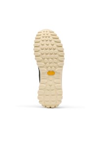 La semelle extérieure Vibram présente une surface beige texturée avec des crampons proéminents et des motifs circulaires, conçue pour améliorer l'adhérence et la durabilité.