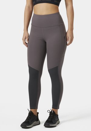 Hoge taille, paarse sportlegging met zwarte accenten en zijrits zak. Gemaakt van rekbare stof, ontworpen voor comfort en bewegingsvrijheid.