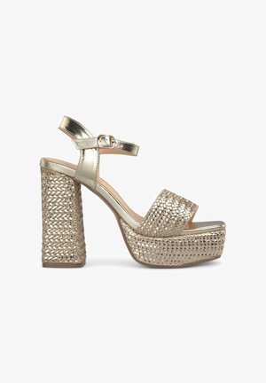 Gold platform sandals with a braided woven design. Features a metallic ankle strap and block heel. Open toe style.