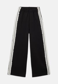 Schwarze weit geschnittene Hosen mit elastischem Bund und seitlichen weißen Streifen, die mit aufwendiger Spitzenverzierung versehen sind.